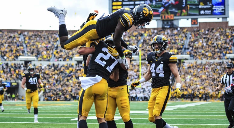Oct 7, 2017; Iowa City, IA, USA; Iowa Hawkeyes defensive back Amani Hooker (27) celebrates his interception with linebacker Ben Niemann (44) and defensive back Michael Ojemudia (11) during the second quarter against the Illinois Fighting Illini at Kinnick