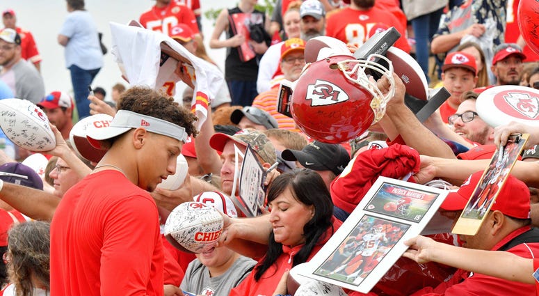 Jul 29, 2018; St. Joseph, MO, USA; Kansas City Chiefs quarterback Patrick Mahomes (15) signs autographs for fans after training camp at Missouri Western State University. Mandatory Credit: Denny Medley-USA TODAY Sports