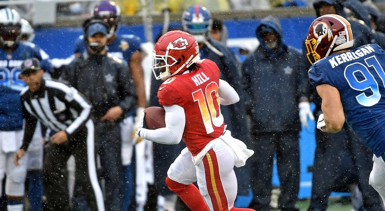 Jan 27, 2019; Orlando, FL, USA; AFC wide receiver Tyreek Hill of the Kansas City Chiefs (10) runs from NFC offense linebacker Ryan Kerrigan of the Washington Redskins (91) in the NFL Pro Bowl football game at Camping World Stadium. Mandatory Credit: Steve