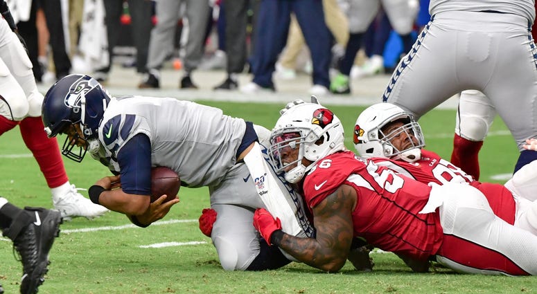 Sep 29, 2019; Glendale, AZ, USA; Arizona Cardinals outside linebacker Terrell Suggs (56) sacks Seattle Seahawks quarterback Russell Wilson (3) in the first half at State Farm Stadium. Mandatory Credit: Matt Kartozian-USA TODAY Sports