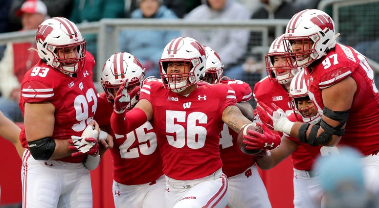 Oct 12, 2019; Madison, WI, USA; Wisconsin Badgers linebacker Zack Baun (56) celebrates with his teammates after his touchdown after an interception and 34 yard return during the 2nd half against Michigan State at Camp Randall Stadium. Mandatory Credit: Mi Zack Baun