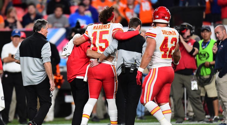 Oct 17, 2019; Denver, CO, USA; Kansas City Chiefs quarterback Patrick Mahomes (15) comes off the field following an injury in the second quarter against the Denver Broncos at Empower Field at Mile High. Mandatory Credit: Ron Chenoy-USA TODAY Sports