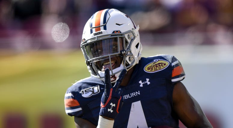 Jan 1, 2020; Tampa, Florida, USA; Auburn Tigers defensive back Noah Igbinoghene (4) reacts to a touchdown during the first quarter against the Minnesota Golden Gophers at Raymond James Stadium. Mandatory Credit: Douglas DeFelice-USA TODAY Sports NOAH IGBINOGHENE