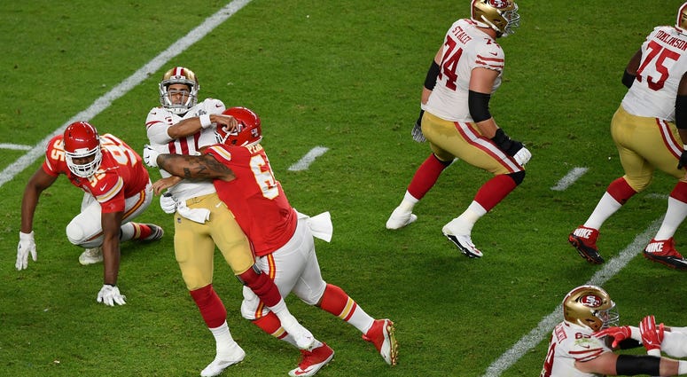 Feb 2, 2020; Miami Gardens, Florida, USA; San Francisco 49ers quarterback Jimmy Garoppolo (10) looks to pass the ball as Kansas City Chiefs defensive tackle Mike Pennel (64) defends during the second quarter in Super Bowl LIV at Hard Rock Stadium. Mandato Mike Pennel
