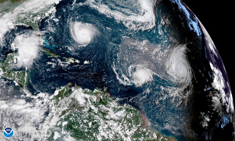 CORRECTS DATE TO SEPT. 11, NOT 1 - This enhanced satellite image made available by NOAA shows Tropical Storm Florence, upper left, in the Atlantic Ocean on Tuesday, Sept. 11, 2018 at 3:30 p.m. EDT. At center is Tropical Storm Isaac and at right is Hurrica CORRECTS DATE TO SEPT. 11, NOT 1 - This enhanced satellite image made available by NOAA shows Tropical Storm Florence, upper left, in the Atlantic Ocean on Tuesday, Sept. 11, 2018 at 3:30 p.m. EDT. At center is Tropical Storm Isaac and at right is Hurrica