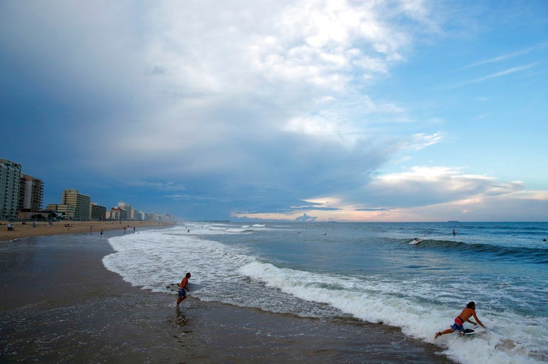 Surfers head to the waves, Tuesday, Sept. 11, 2018, in Virginia Beach, Va., before the arrival of Hurricane Florence Surfers head to the waves, Tuesday, Sept. 11, 2018, in Virginia Beach, Va., before the arrival of Hurricane Florence