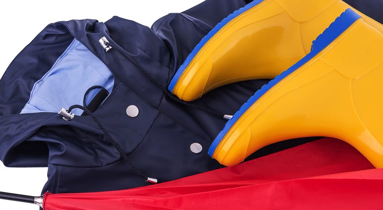 Raincoat, umbrella and rubber boots Rain gear Raincoat and umbrella and rubber boots on a white background. Protective, footwear. (Photo credit: Tetiana Rozhnovska/Dreamstime)