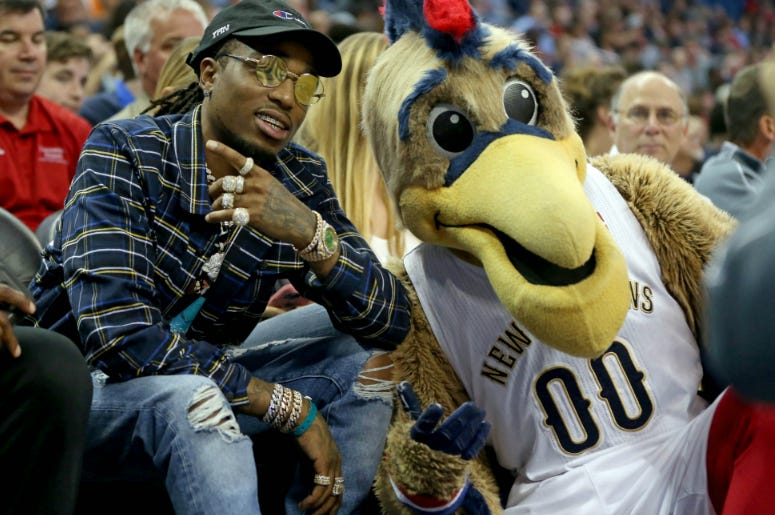 Quavo from the hip-hop group Migos poses with the New Orleans Pelicans mascot in the second half of the game against the Toronto Raptors at the Smoothie King Center. Quavo from the hip-hop group Migos poses with the New Orleans Pelicans mascot in the second half of the game against the Toronto Raptors at the Smoothie King Center.