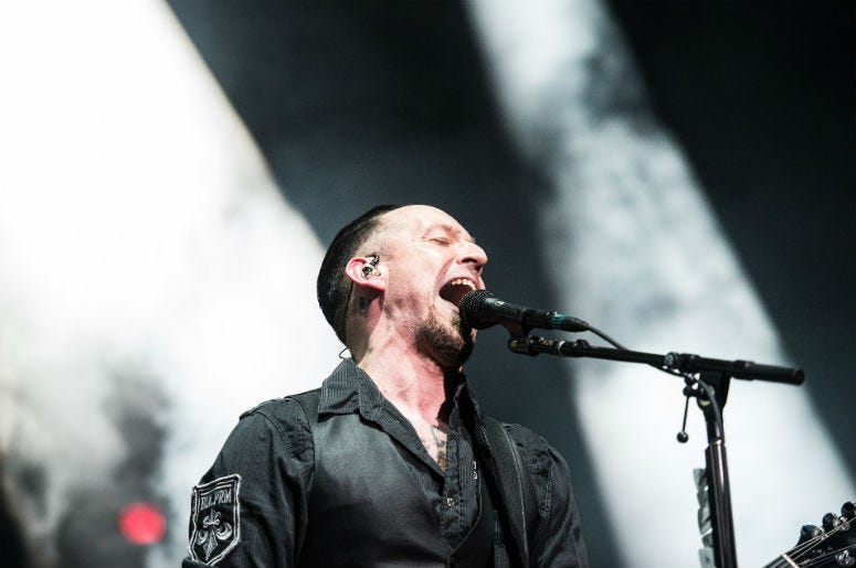 Michael Poulsen of Volbeat performs during Avenged Sevenfold's The Stage World Tour featuring Avenged Sevenfold, Volbeat and Motionless in White at Giant Center. Michael Poulsen of Volbeat performs during Avenged Sevenfold's The Stage World Tour featuring Avenged Sevenfold, Volbeat and Motionless in White at Giant Center.