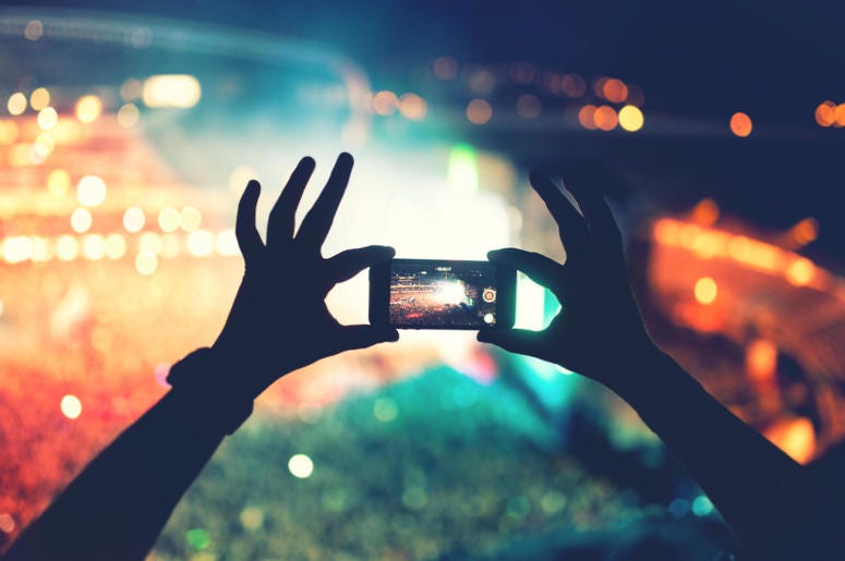 Silhouette of hands using camera phone to take pictures and videos at pop concert, festival Silhouette of hands using camera phone to take pictures and videos at pop concert, festival