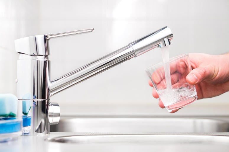Filling glass with tap water. Modern faucet and sink. Filling glass with tap water. Modern faucet and sink.