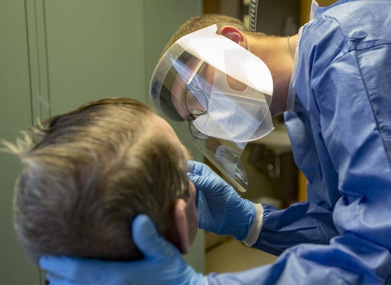 U.S. Army Spc. Austin T. Runnels, a combat medic specialist assigned to the 223rd Engineer Battalion, Mississippi National Guard administers a COVID-19 test at the Mississippi State Veterans Home in Kosciusko, Miss., May 15, 2020.