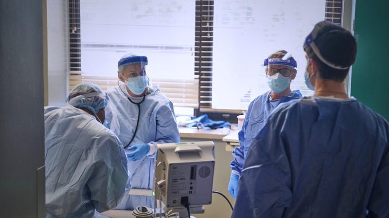 Cocoa Beach, Fla., native U.S. Navy Lt. j.g. Sandra Link (left) and Warsaw, Ind., native Petty Officer 3rd Class Michael Blue, both Sailors with Expeditionary Medical Facility-M, assist a patient at Baton Rouge General Mid City campus May 5, 2020.
