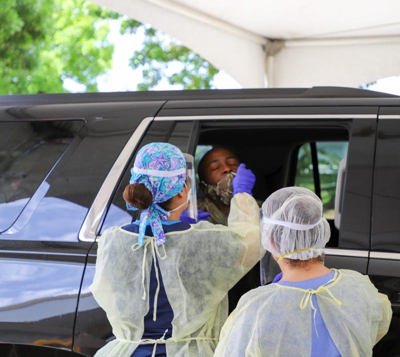 Brig. Gen. Kodjo Knox-Limbacker, the adjutant general, receives nasal swab by Dr. Torres of the Puerto Rico VA Medical Center, at the Barron Spot Village Mall in St. Croix, during V.I. Department of Veterans Affairs drive-through screenings.