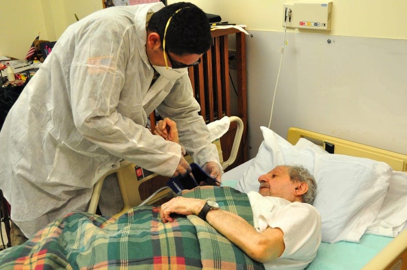 U.S. Army Spc. Jabari Ashanti, a Combat Medic with the 1st Battalion, 114th Infantry Regiment, New Jersey Army National Guard (NJARNG), checks a resident’s blood pressure at the New Jersey Veterans Memorial Home at Menlo Park in Edison, N.J., April 17, 20