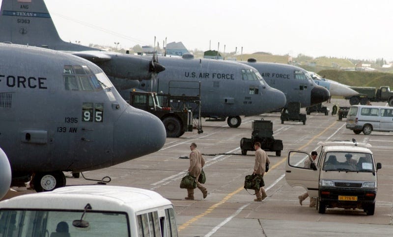 C-130 Hercules aircrew members board their aircraft for an Operation Enduring Freedom mission at Karshi-Khanabad Air Base, Uzbekistan, on April 19, 2005.