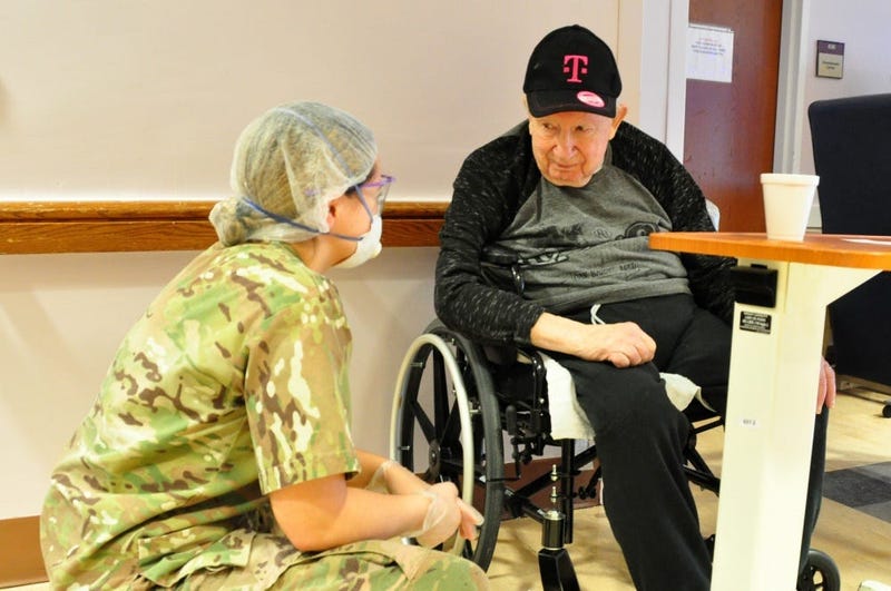 U.S. Army Spc. Olivia Cordero, a Combat Medic with the 1st Battalion, 114th Infantry Regiment, New Jersey Army National Guard (NJARNG), checks on a resident of the New Jersey Veterans Memorial Home at Menlo Park in Edison, N.J., April 17, 2020.