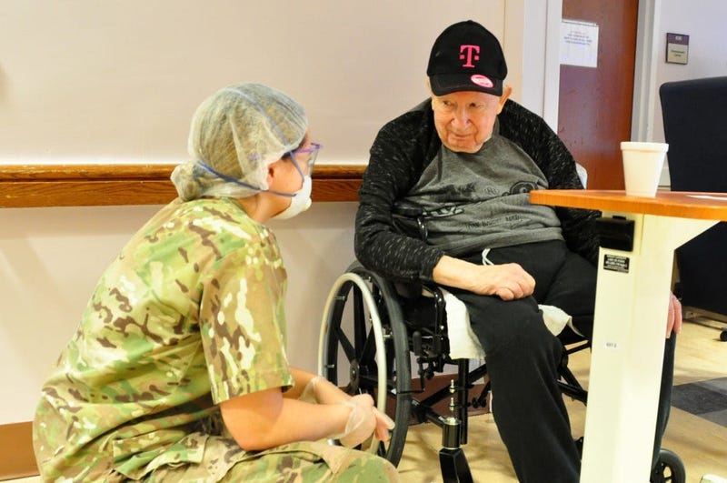 U.S. Army Spc. Olivia Cordero, a Combat Medic with the 1st Battalion, 114th Infantry Regiment, New Jersey Army National Guard (NJARNG), checks on a resident of the New Jersey Veterans Memorial Home at Menlo Park in Edison, N.J., April 17, 2020. 