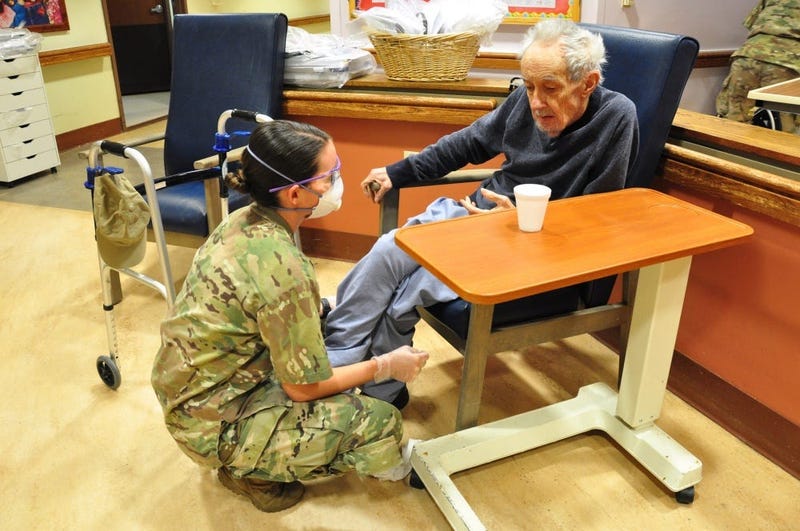 U.S. Army Spc. Laurel Yerg, a Combat Medic with the 1st Battalion, 114th Infantry Regiment, New Jersey Army National Guard (NJARNG), checks on a resident of the New Jersey Veterans Memorial Home at Menlo Park in Edison, N.J., April 17, 2020.
