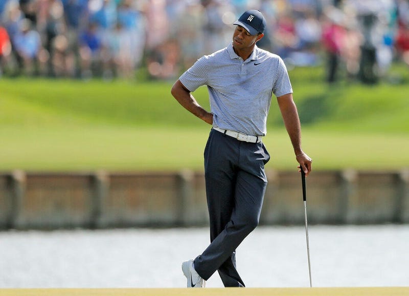 Tiger Woods reacts to hitting his drive into the water on the 17th hole during the second round of The Players Championship golf tournament Friday, March 15, 2019, in Ponte Vedra Beach, Fla