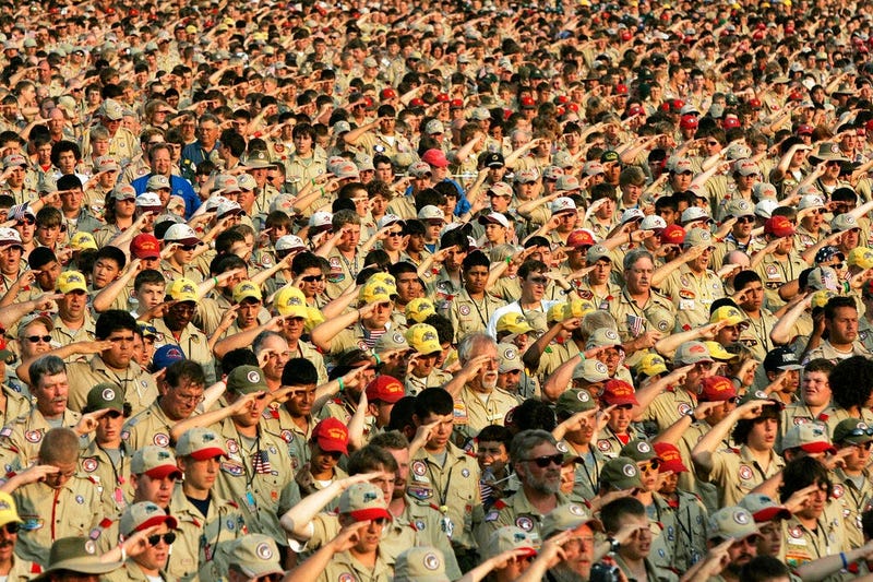 Boy Scouts salute as they recite the Pledge of Allegiance during the Boy Scout Jamboree