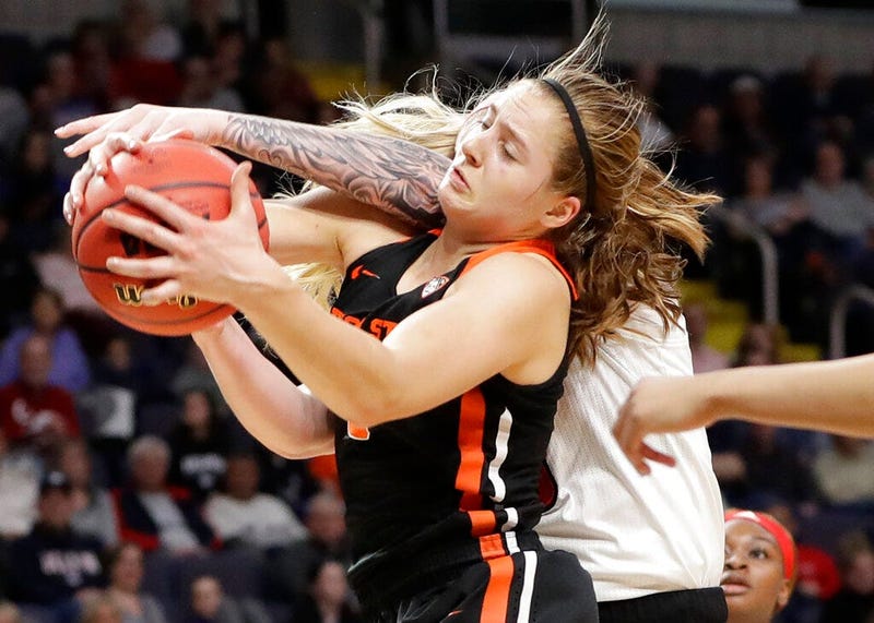 Oregon State guard Mikayla Pivec (0) battles for the ball with Louisville forward Sam Fuehring during the first half of a regional semifinal game in the NCAA women's college basketball tournament, Friday, March 29, 2019, in Albany, N.Y.