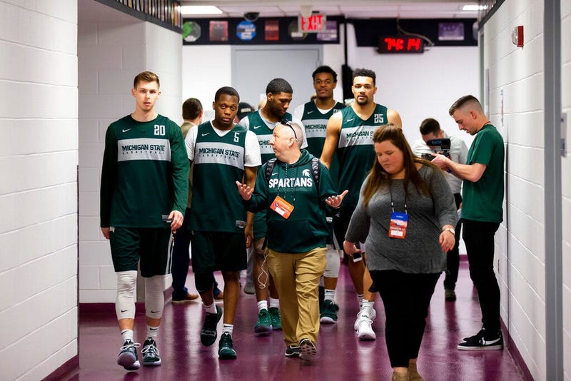 Michigan State guard Matt McQuaid, left, guard Cassius Winston, forward Aaron Henry, forward Xavier Tillman and forward Kenny Goins walk to an NCAA men's college basketball individual news conferences in Washington, Saturday, March 30, 2019. Michigan Stat