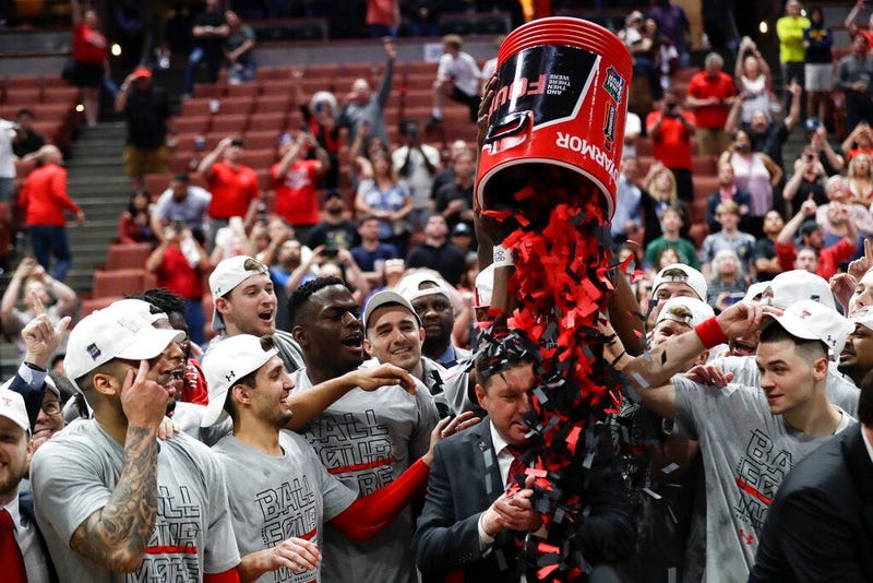 Texas Tech players shower coach Chris Beard with confetti after their win against Gonzaga during the West Regional final in the NCAA men's college basketball tournament Saturday, March 30, 2019, in Anaheim, Calif. Texas Tech won 75-69.