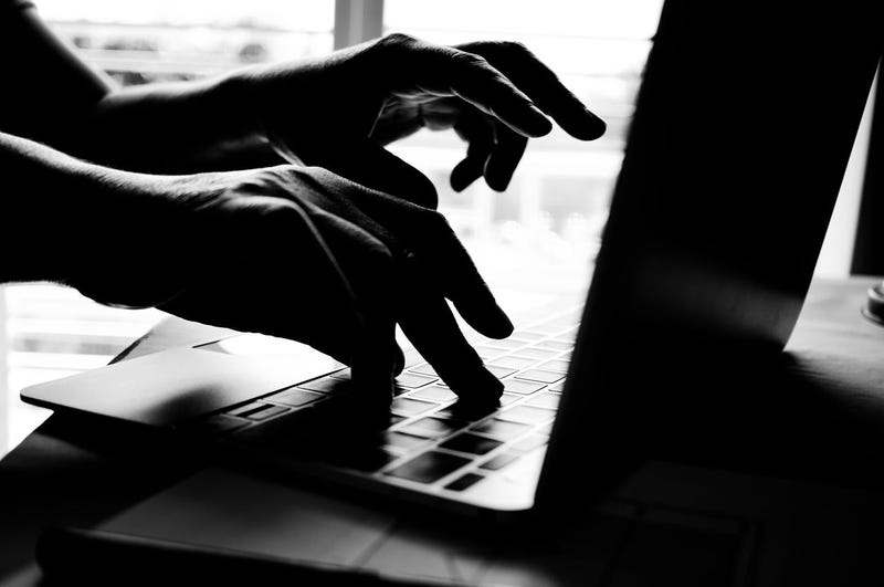 Hands of anonymous hackers typing code on keyboard of laptop for remotely reach and receiving personal information online networking, Internet Crime Payment Security Concept, Silhouette black white