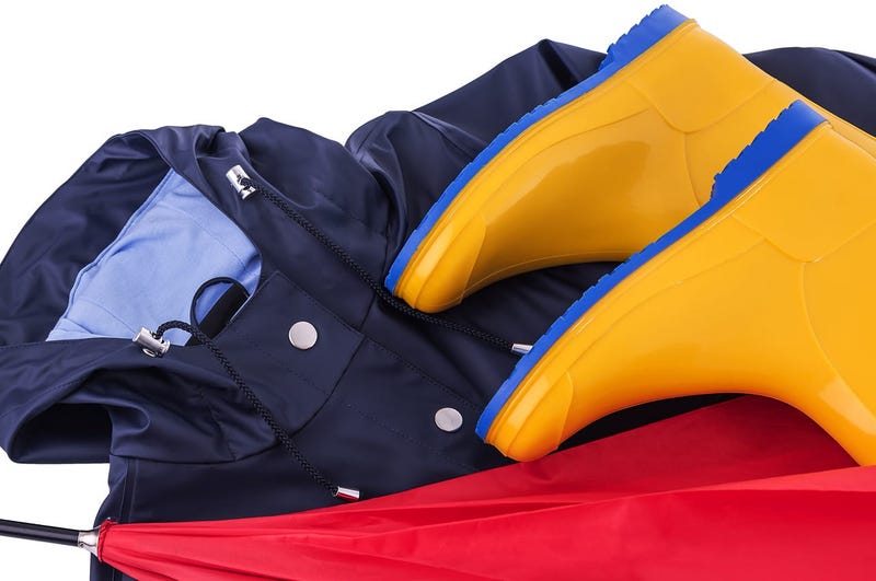 Rain gear Raincoat and umbrella and rubber boots on a white background. Protective, footwear. (Photo credit: Tetiana Rozhnovska/Dreamstime)