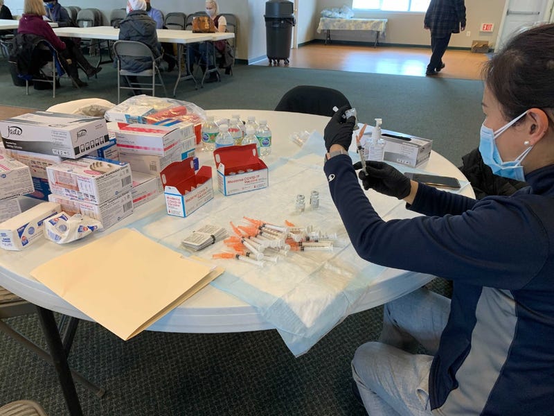 Kayly Sie, cofounder and president of Wellness Pharmacy, preparing COVID-19 vaccine doses.