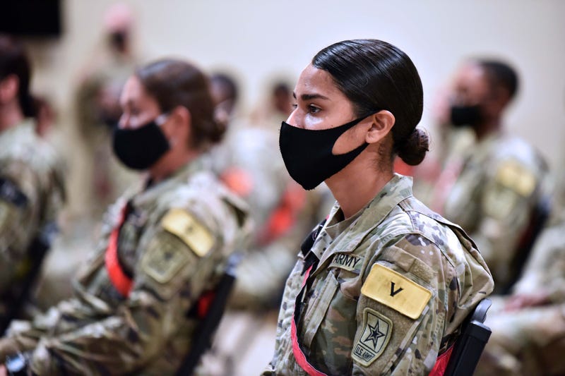 Advanced individual training soldiers wearing face masks listen to Maj. Gen. Dennis LeMaster