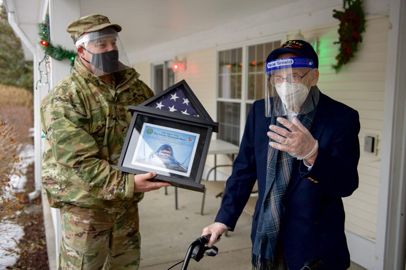 Col. Adam Rice, vice wing commander of the 158th Fighter Wing, Vermont Air National Guard, presents a flag flown in the F-35A Lightning II to WWII veteran Lenny Roberge, Vermont’s oldest living veteran.