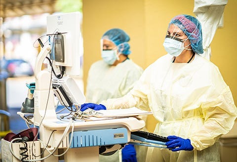 Nursing staff man a COVID-19 screening point at the San Juan VA Medical Center.