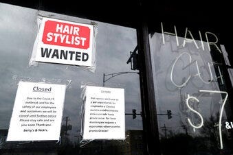 FILE - In this April 30 ,2020 file photo, a barber shop shows closed and hiring sign during the COVID-19 in Chicago. (AP Photo/Nam Y. Huh, File)