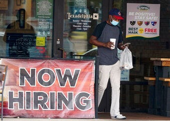 FILE - In this Sept. 2, 2020, file photo, a customer walks past a now hiring sign at an eatery in Richardson, Texas. The Labor Department reported unemployment numbers Thursday, Sept. 3. (AP Photo/LM Otero, File)