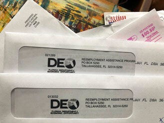 Envelopes from the Florida Department of Economic Opportunity Reemployment Assistance Program are shown, Thursday, Nov. 5, 2020, in Surfside, Fla. (AP Photo/Wilfredo Lee)