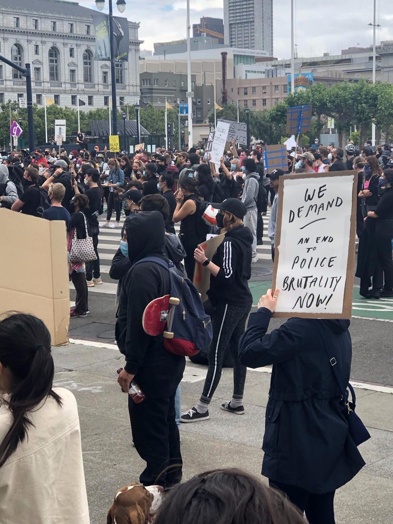A protester holds a sign at City Hall in San Francisco.