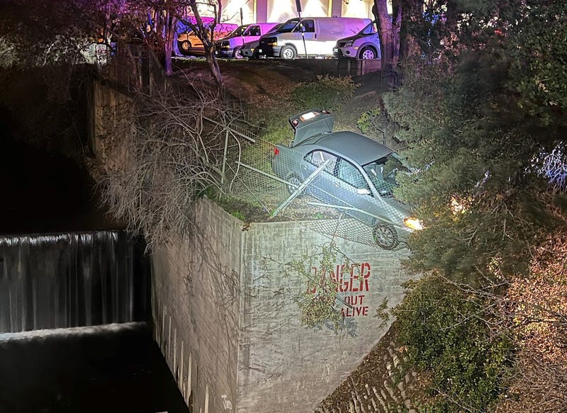 Two people have been arrested in the East Bay after they were found dangling off the side of a canal while allegedly attempting to flee police.