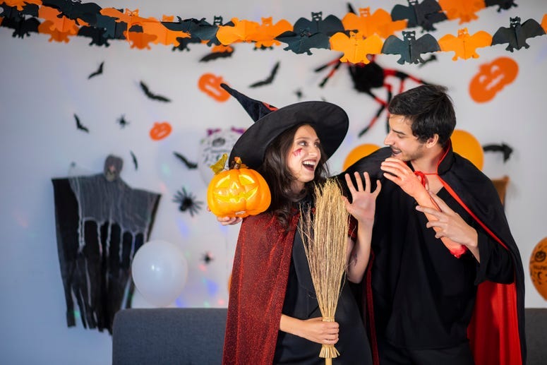 Couple dressed as witch and vampire.