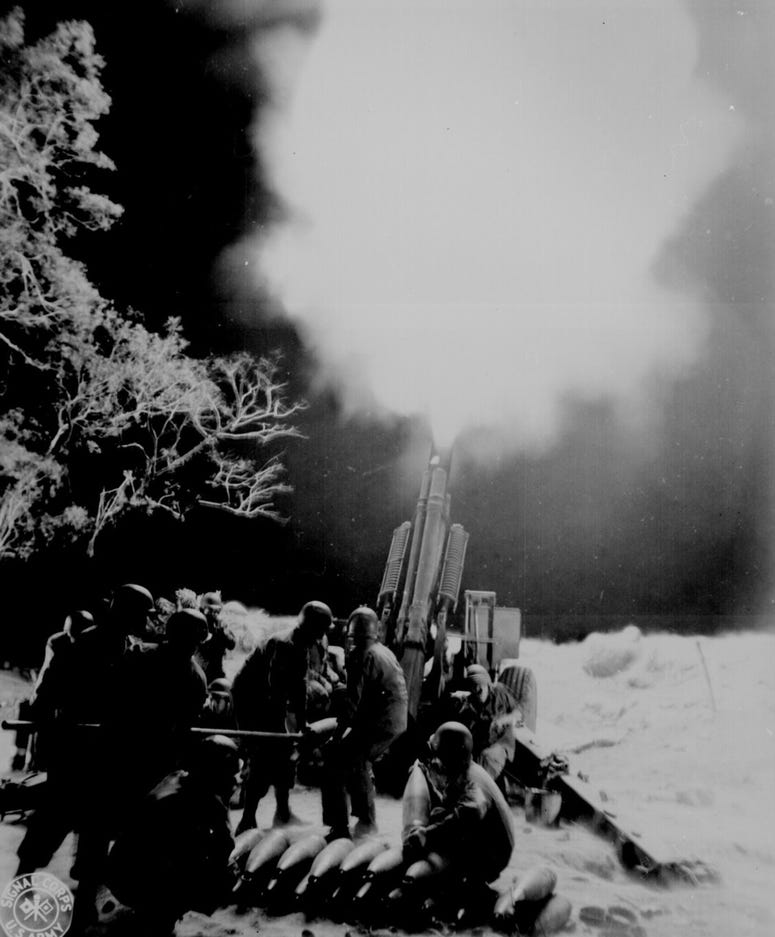 Soldiers of C Battery, 90th Field Artillery, lay down a barrage on Japanese artillery positions in Balete Pass in the Philippines, April 19, 1945.