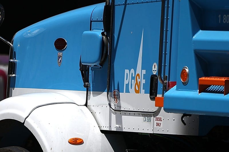 SAN FRANCISCO, CA - JULY 30: Pedestrians walk by a Pacific Gas and Electric (PG&E) truck at a job site on July 30, 2014 in San Francisco, California. A federal grand jury has added 27 new charges, including obstruction of justice, the criminal case agains
