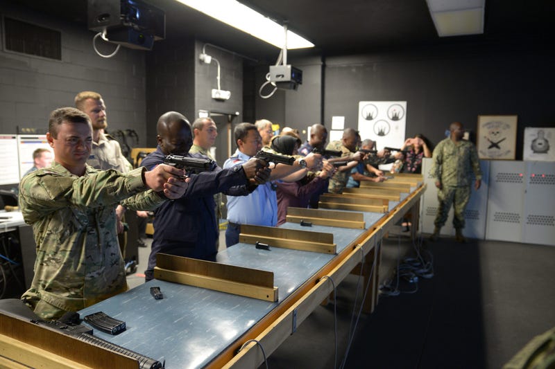 Training Security Assistance Field Activity Foreign Students try out the Gunner's Mate 'A' School's Fire Arms Training Simulator