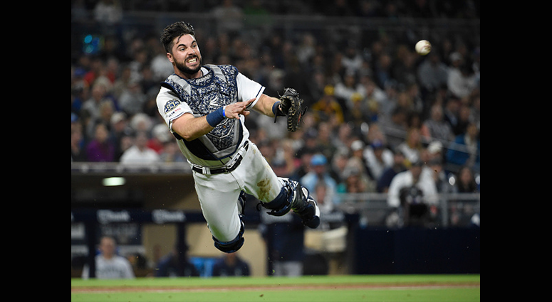 APRIL 23: Austin Hedges #18 of the San Diego Padres makes a throw to first base to get the out on Mallex Smith #0 of the Seattle Mariners during the third inning of a baseball game at Petco Park April 23, 2019 in San Diego, California. (Photo by Denis Por