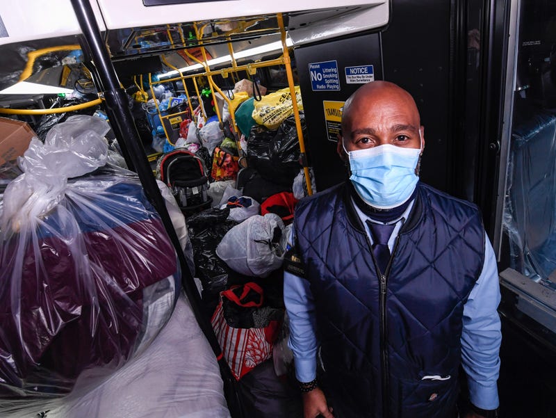 MTA employee with donated goods on bus