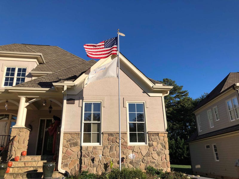 A woman whose son was killed in the Feb. 15 Aurora warehouse shooting was ordered by her homeowners’ association to remove an Aurora Strong flag from a pole outside her North Carolina home