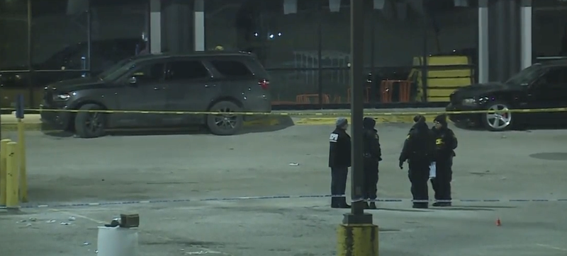 Police officers stand outside in bitter cold at the site of a deadly shooting outside the 9ine Ultra Lounge in the Kansas City area.