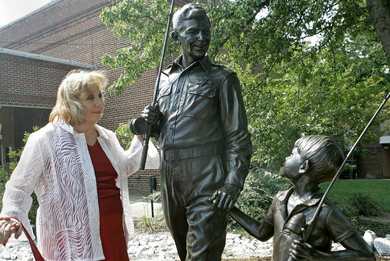 FILE - In this Sept. 6, 2007 file photo, actor Betty Lynn, who played Thelma Lou on "The Andy Griffith Show," pauses at a statue of Andy and Opie Taylor in Mount Airy, N.C. Lynn died Saturday, Oct. 16, 2021, after a brief illness, The Andy Griffith Museum in Mount Airy announced in a statement. She was 95.
