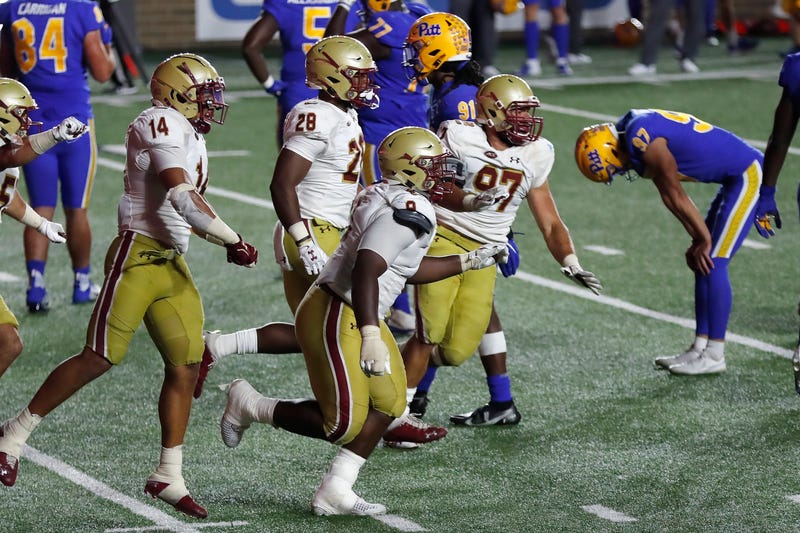 Boston College players celebrate after Pittsburgh kicker Alex Kessman (97) missed an extra-point attempt, giving the Eagles a 31-30 overtime win in an NCAA college football game, Saturday, Oct. 10, 2020, in Boston