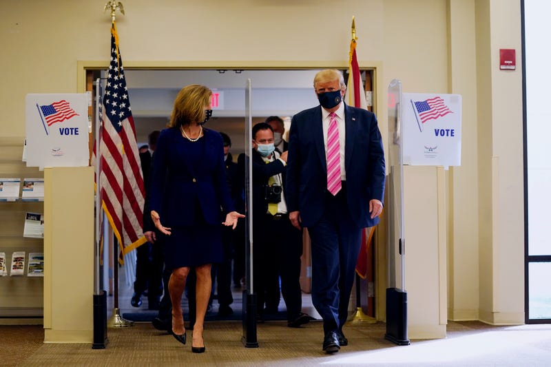 President Donald Trump walks with Wendy Sartory Link, Supervisor of Elections Palm Beach County, after casting his ballot for the presidential election, Saturday, Oct. 24, 2020, in West Palm Beach, Fla.